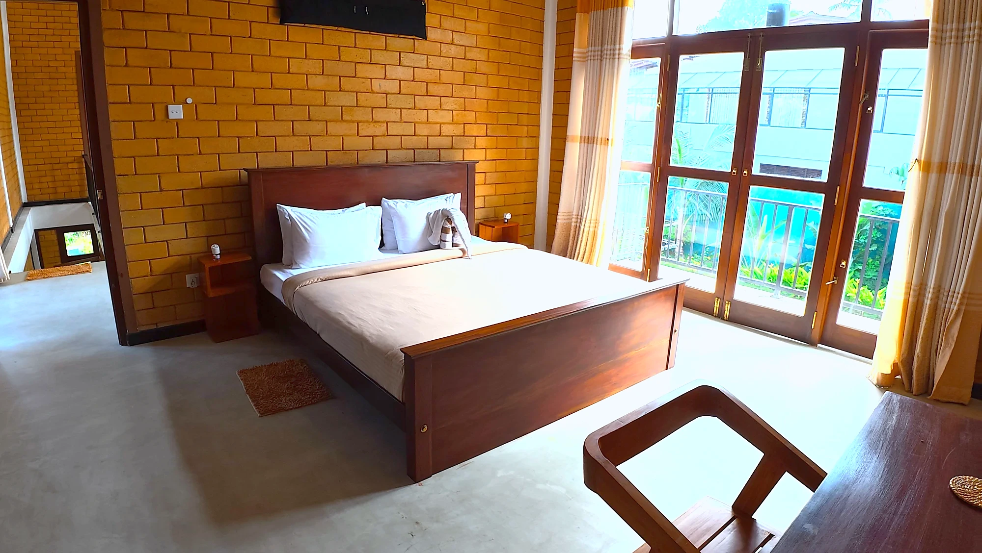 Bedroom with tall garden-facing windows — Syndeo Garden, Hikkaduwa