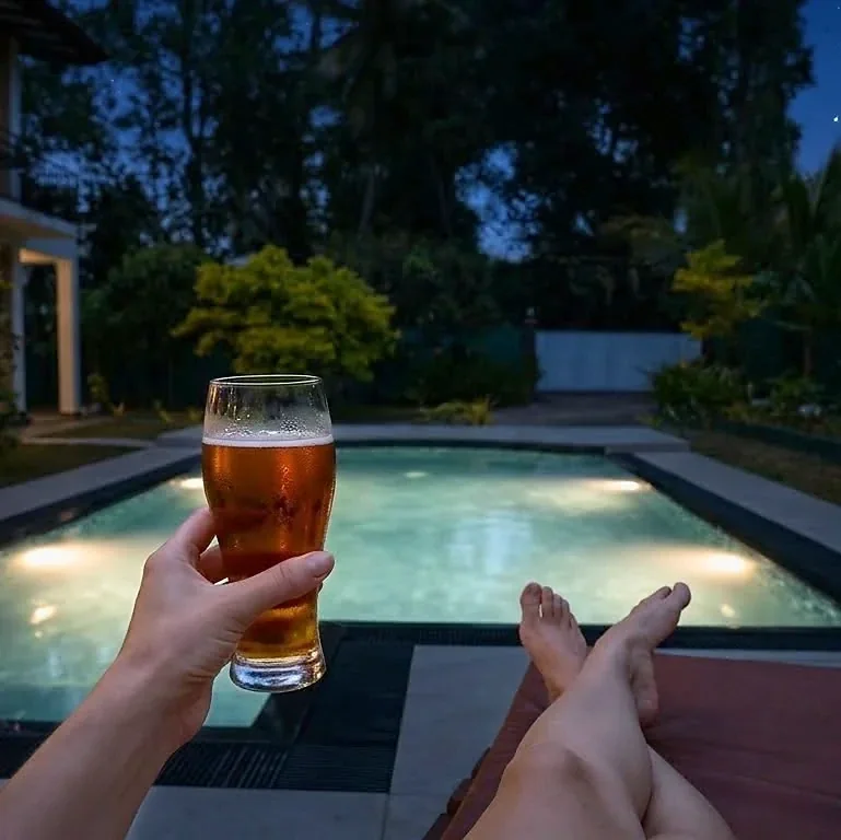 Relaxing beside the pool at dusk — Syndeo Garden, Hikkaduwa