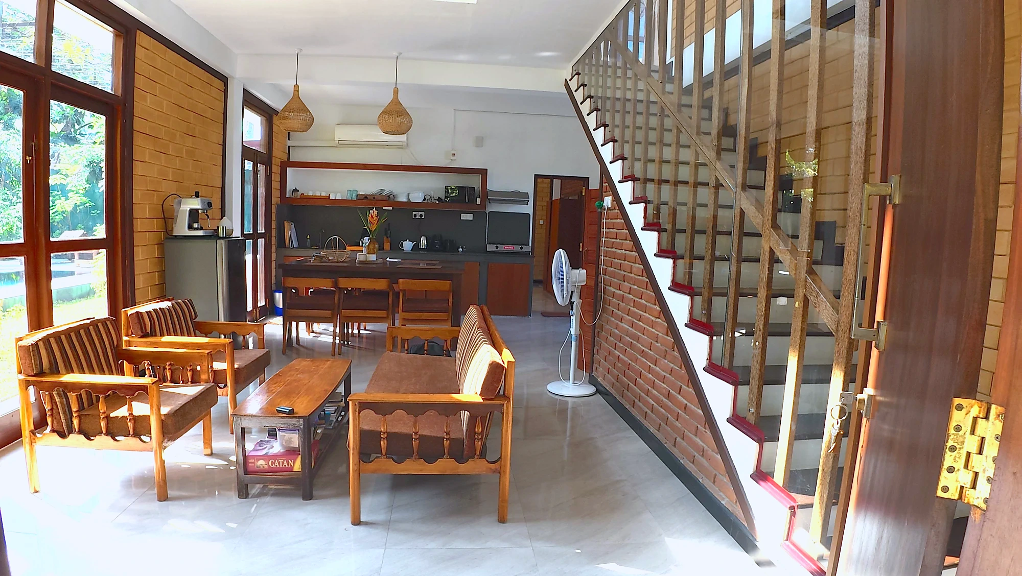 Spacious living and dining area with a wooden staircase — Syndeo Garden, Hikkaduwa