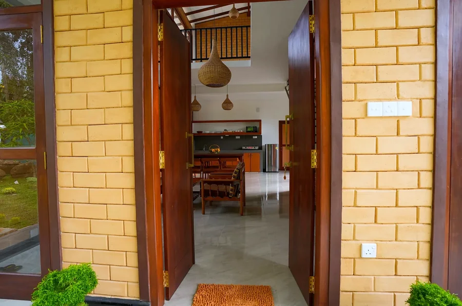 Villa entrance with brick walls and wooden doors — Syndeo Garden, Hikkaduwa